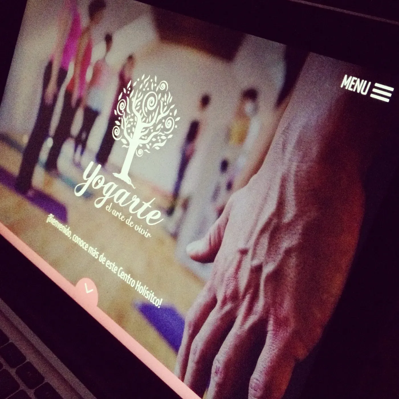 A holistic centre website open on a laptop.