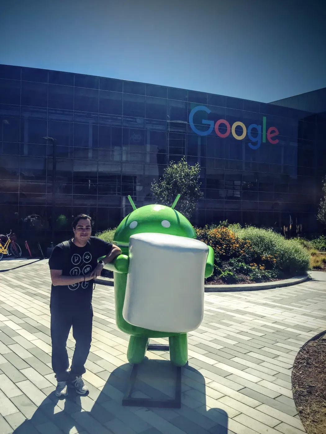 Standing beside an Android statue at a Google campus.